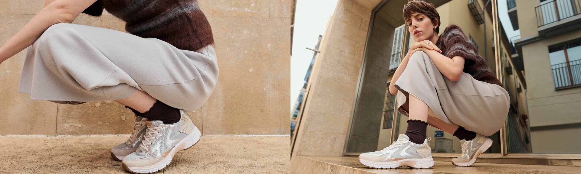 Una donna è accovacciata all'aperto davanti a degli edifici e indossa sneakers chiare, calze scure, pantaloni larghi grigi e un maglione marrone a righe. Il focus è sulle scarpe. | © Gabor Shoes GmbH, Germania